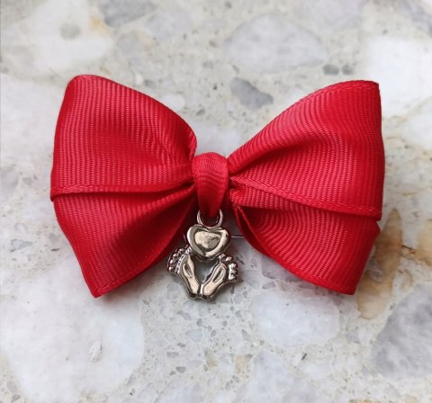Czerwona kokardka na agrafce ze stopkami i sercem do wózka